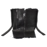 a matte black full grain horse culatta leather collar, meticulously hand stitched with an open seam construction. the scarf features a stonewashed ramie lining and riri zipper closures adorned with hand forged .925 sterling silver zipper pulls. available to buy online from avant garde leather studio atelierskn.com