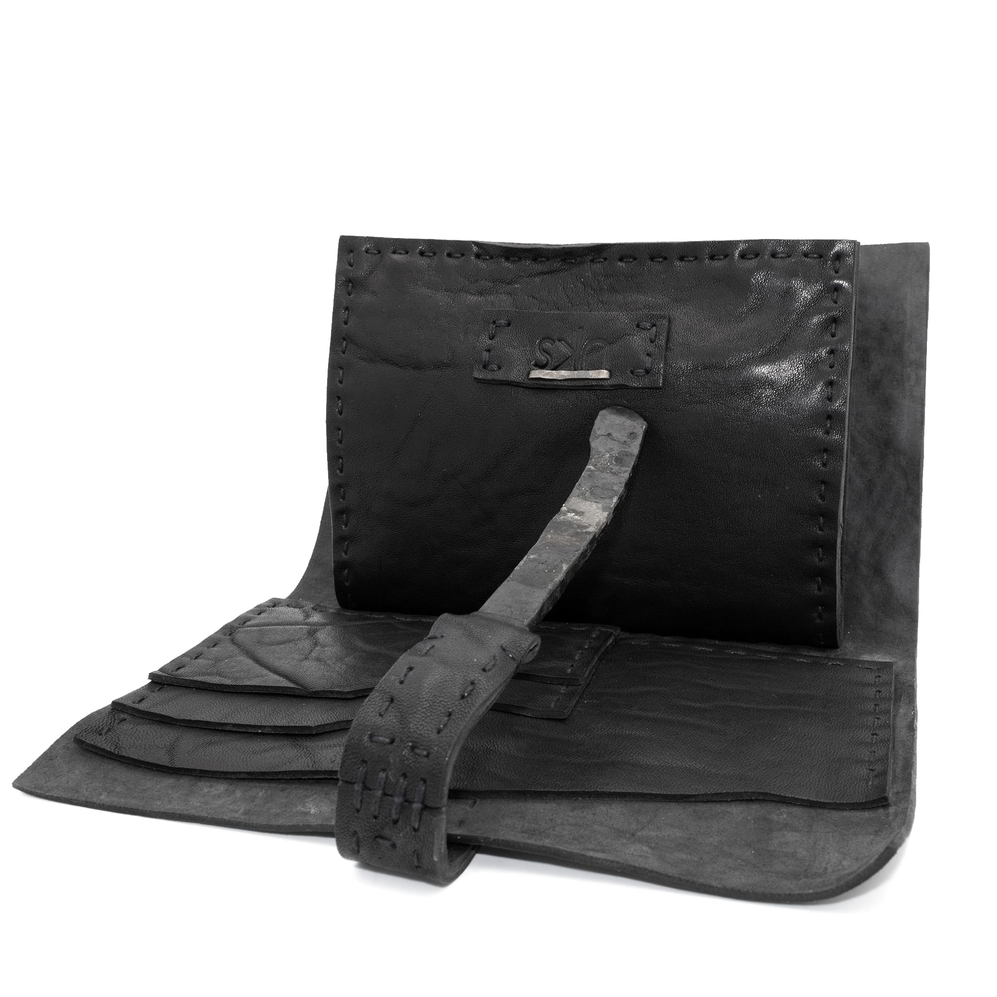 compact matte black horse leather wallet with a forged-iron shank closure and a zipper coin pocket, completely handmade in the UK by atelier SKN