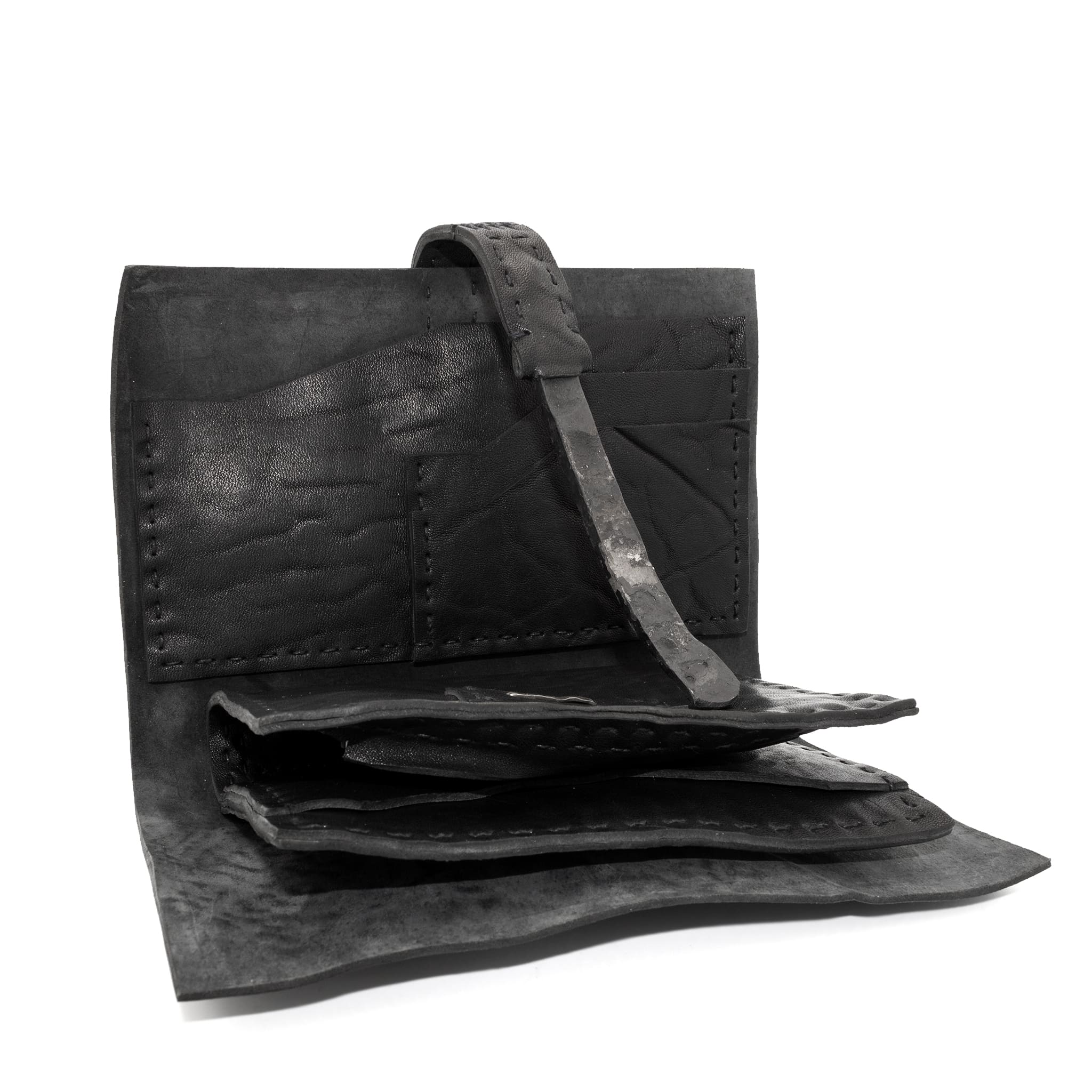 compact matte black horse leather wallet with a forged-iron shank closure and a zipper coin pocket, completely handmade in the UK by atelier SKN