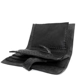 compact matte black horse leather wallet with a forged-iron shank closure and a zipper coin pocket, completely handmade in the UK by atelier SKN