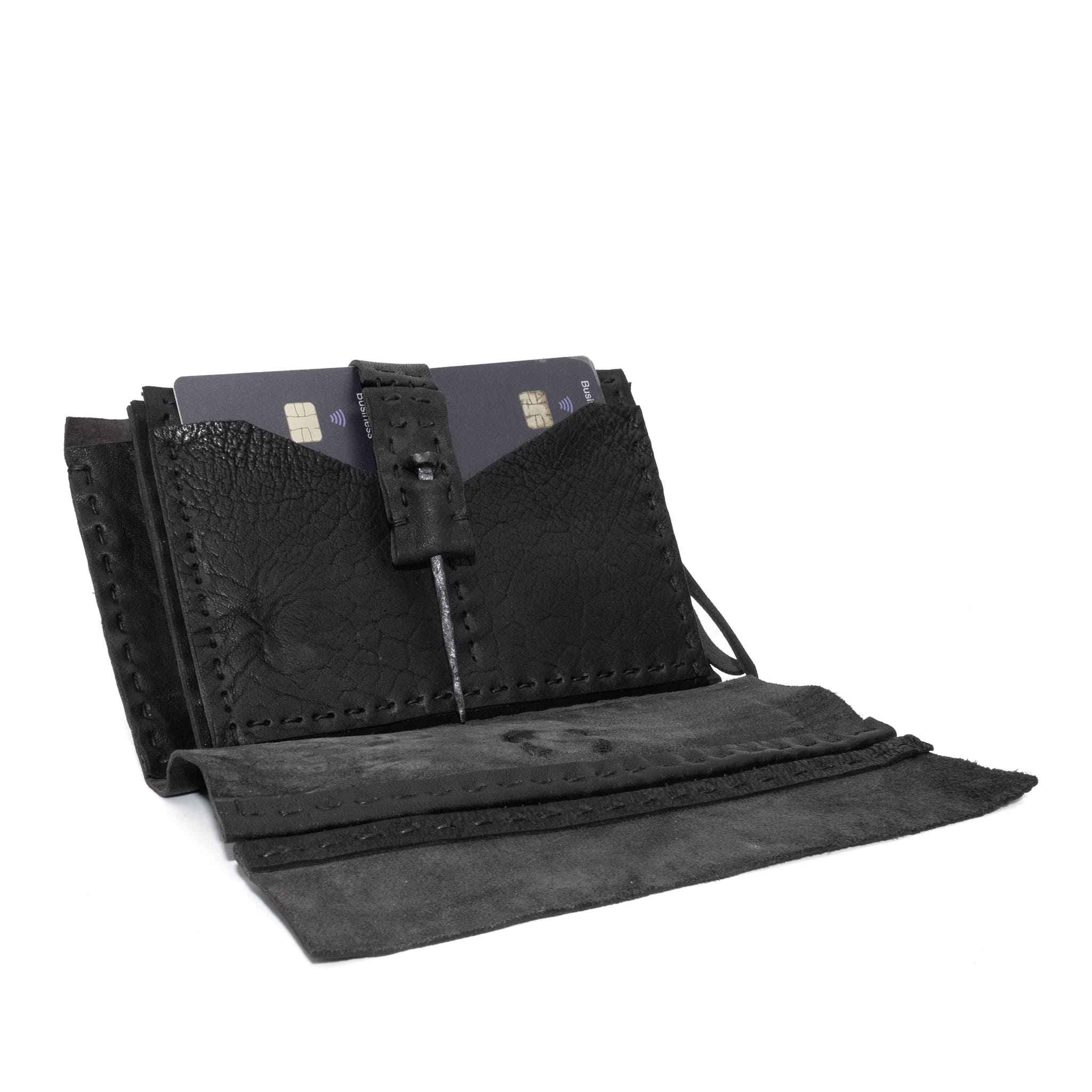 hand stitched matte black horse culatta leather long wallet with a technical open seam construction, multiple card slots and a large note pocket. the wallet is adorned with hand forged iron and .925 sterling silver hardware. available to buy online from artisanal leather studio atelier skn.