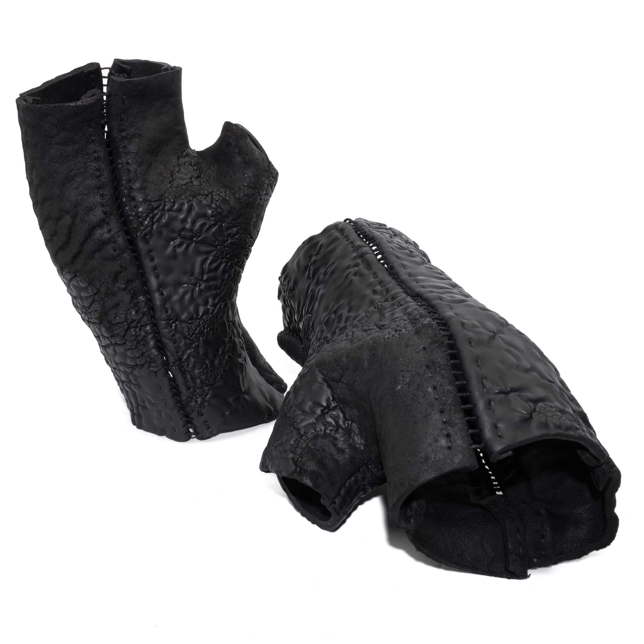 hand stitched over a 35hr period the washed reverse culatta gloves feature an open seam panel construction, a distressed black dye treatment and japanese linen thread for the stitching. the gloves are wet moulded on the body and available to buy online from avant garde leather studio atelierskn.com 