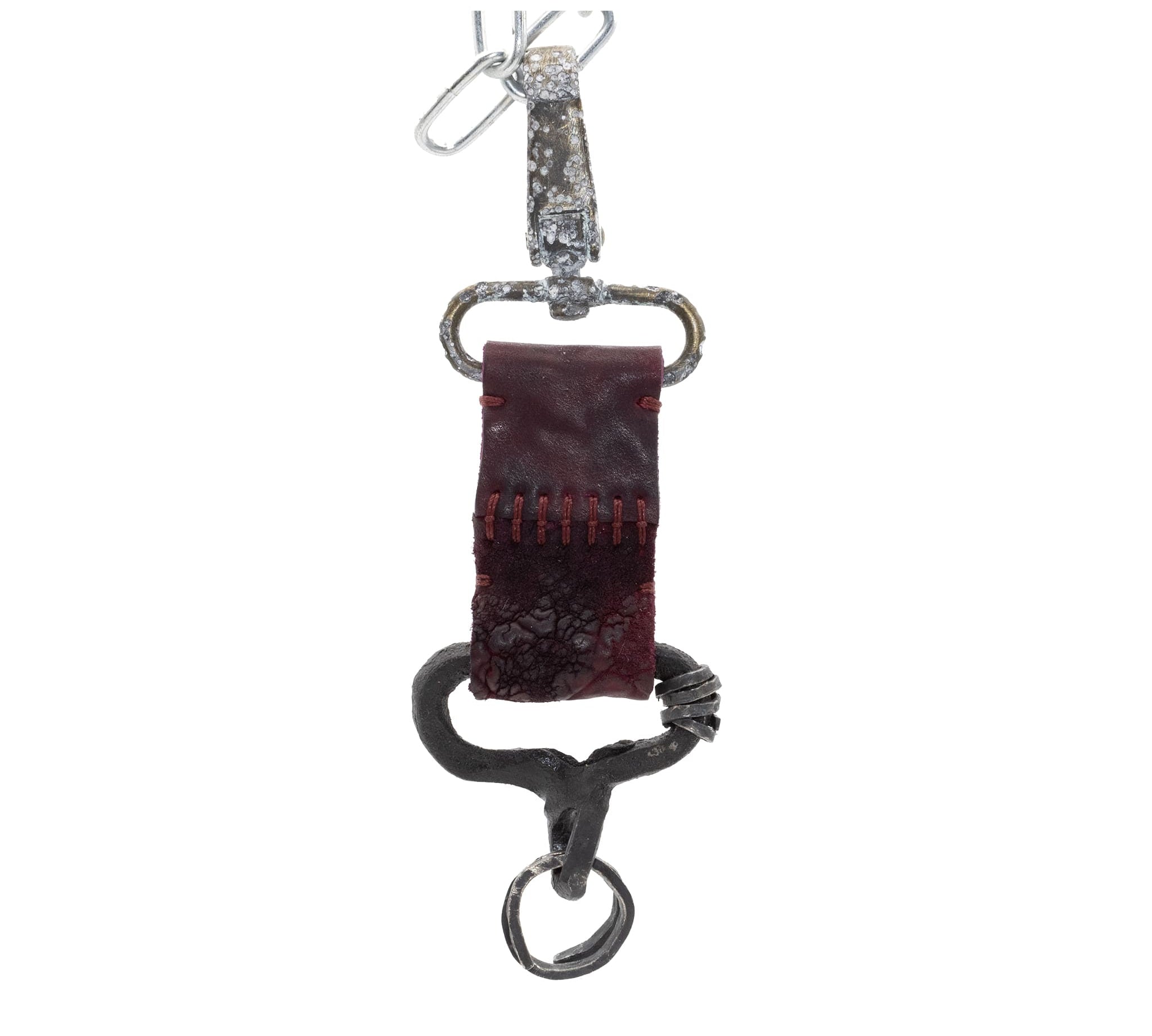 hand stitched and hand dyed horse culatta leather keychain adorned with hand forgediron and .925 sterling silver hardware. Sitting alongside a distressed swivel clip available online from artisanal leather studio atelier skn.