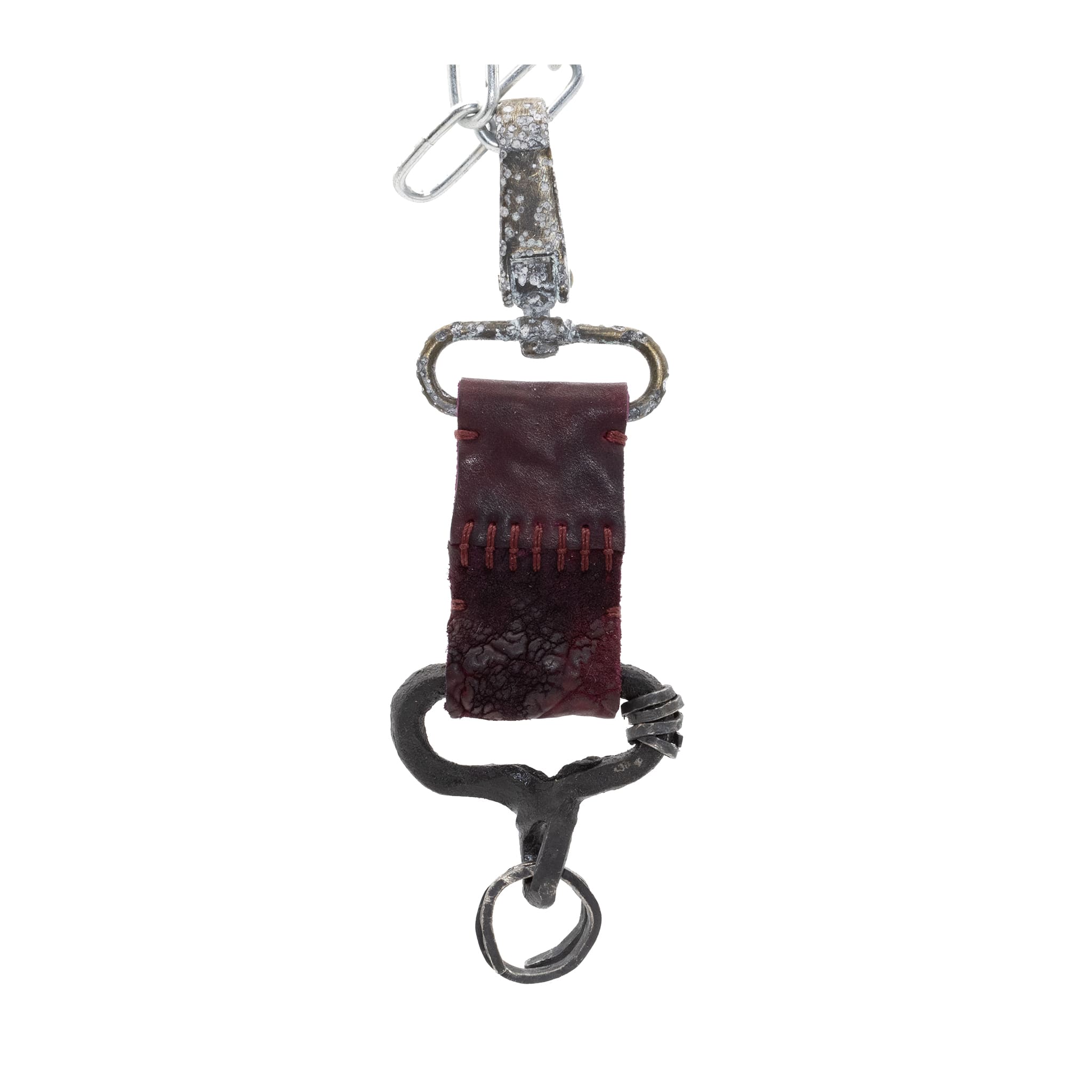 hand stitched and hand dyed horse culatta leather keychain adorned with hand forgediron and .925 sterling silver hardware. Sitting alongside a distressed swivel clip available online from artisanal leather studio atelier skn.