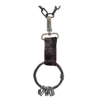 the hand sewn reverse culatta leather prison keys feature a blood red dye treatment and a distressed and corroded swivel clip. a large hand forged black iron ring holds the triple oxidised .925 silver key rings.