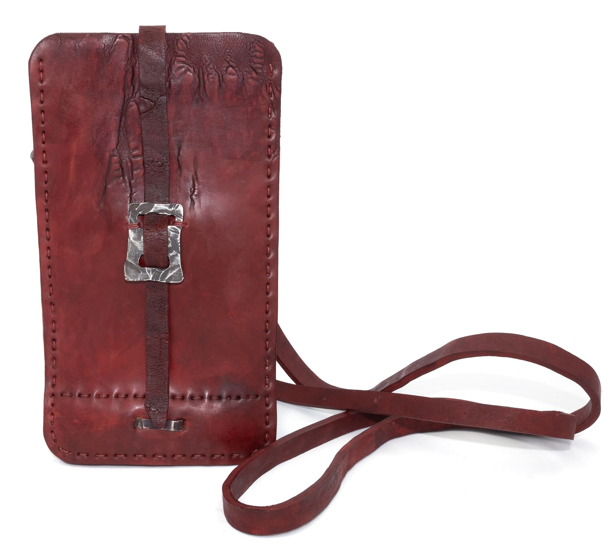 avant garde hand stitched culatta horse leather phone case, with a blood red dye finish. the phone case features a minimal silhouette with tonal japanese linen stitching and hand forged .925 sterling silver hardware. the phone holder is available to buy online from artisanal designer atelierskn.com 