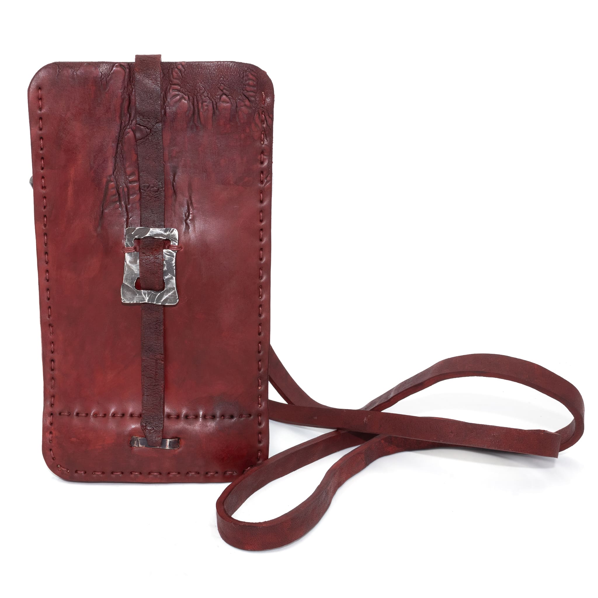 avant garde hand stitched culatta horse leather phone case, with a blood red dye finish. the phone case features a minimal silhouette with tonal japanese linen stitching and hand forged .925 sterling silver hardware. the phone holder is available to buy online from artisanal designer atelierskn.com 
