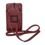 avant garde hand stitched culatta horse leather phone case, with a blood red dye finish. the phone case features a minimal silhouette with tonal japanese linen stitching and hand forged .925 sterling silver hardware. the phone holder is available to buy online from artisanal designer atelierskn.com 