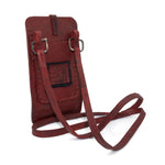 avant garde hand stitched culatta horse leather phone case, with a blood red dye finish. the phone case features a minimal silhouette with tonal japanese linen stitching and hand forged .925 sterling silver hardware. the phone holder is available to buy online from artisanal designer atelierskn.com 
