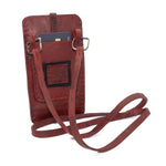 avant garde hand stitched culatta horse leather phone case, with a blood red dye finish. the phone case features a minimal silhouette with tonal japanese linen stitching and hand forged .925 sterling silver hardware. the phone holder is available to buy online from artisanal designer atelierskn.com 