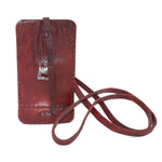 avant garde hand stitched culatta horse leather phone case, with a blood red dye finish. the phone case features a minimal silhouette with tonal japanese linen stitching and hand forged .925 sterling silver hardware. the phone holder is available to buy online from artisanal designer atelierskn.com 