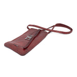 avant garde hand stitched culatta horse leather phone case, with a blood red dye finish. the phone case features a minimal silhouette with tonal japanese linen stitching and hand forged .925 sterling silver hardware. the phone holder is available to buy online from artisanal designer atelierskn.com 