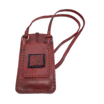 avant garde hand stitched culatta horse leather phone case, with a blood red dye finish. the phone case features a minimal silhouette with tonal japanese linen stitching and hand forged .925 sterling silver hardware. the phone holder is available to buy online from artisanal designer atelierskn.com 