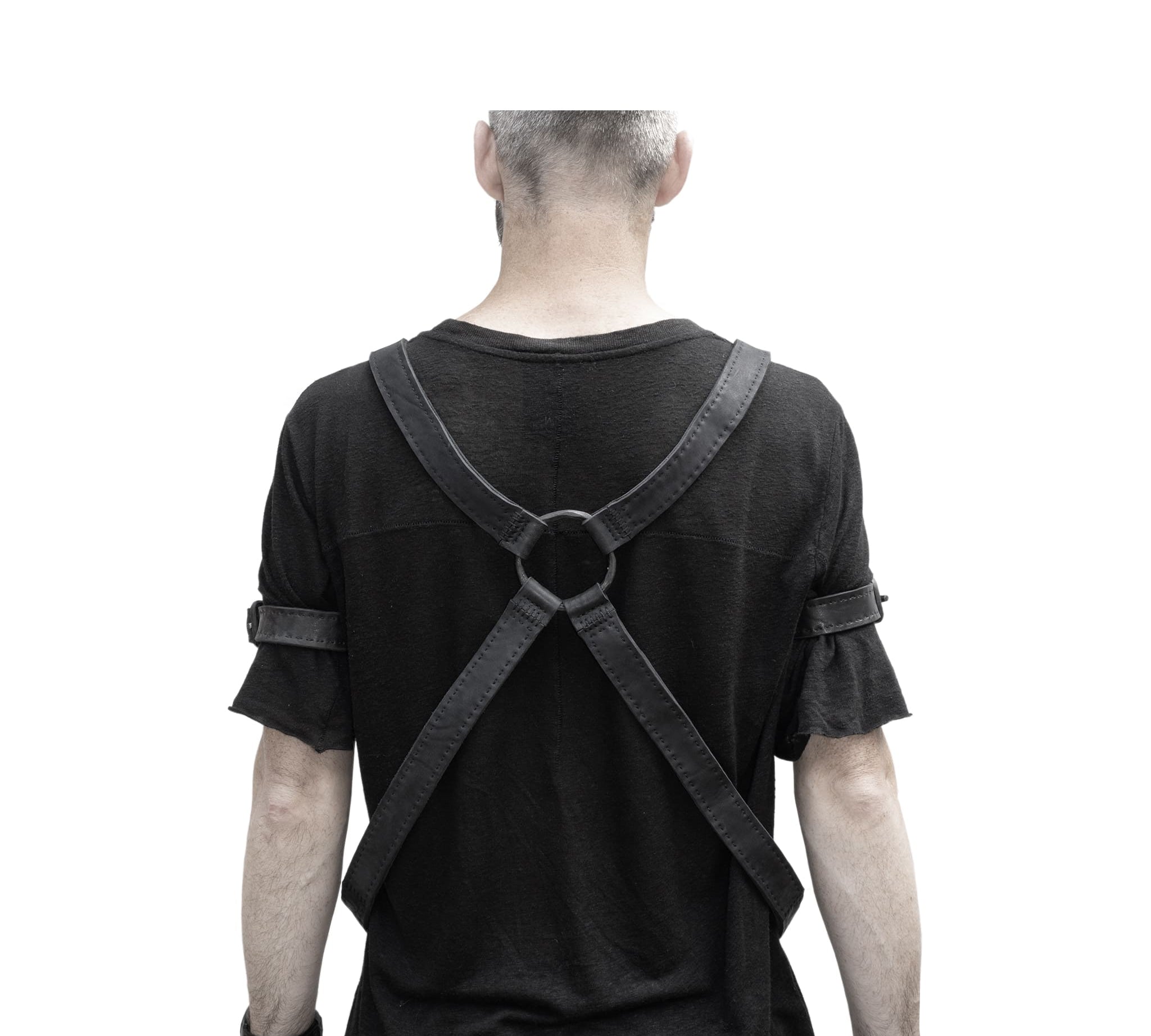 avant garde hand stitched horse culatta leather body harness, with an iron dye finish. the harness features a minimal silhouette with tonal japanese linen stitching and hand forged iron ring hardware. the leather harness is available to buy online from artisanal designer atelierskn.com 
