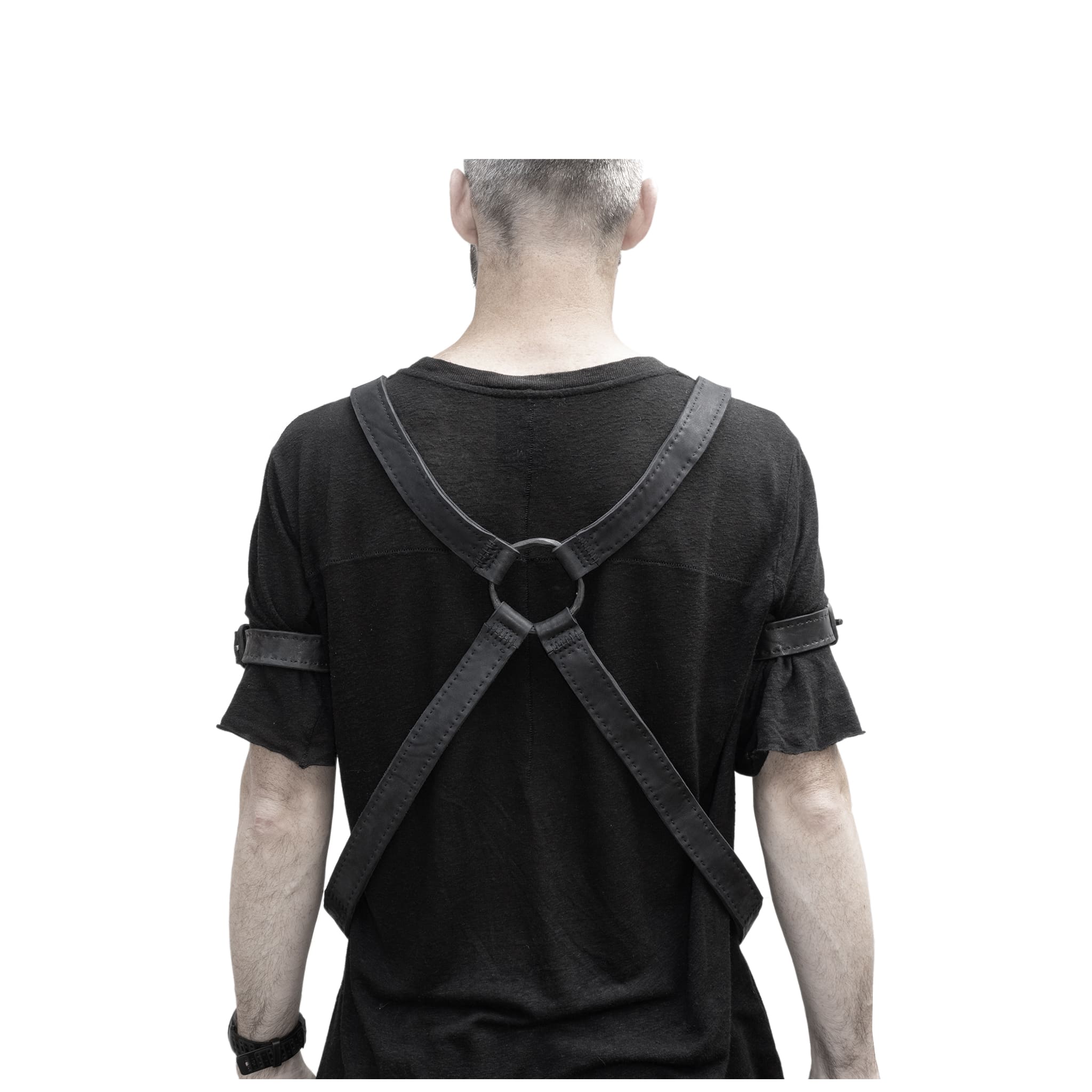 avant garde hand stitched horse culatta leather body harness, with an iron dye finish. the harness features a minimal silhouette with tonal japanese linen stitching and hand forged iron ring hardware. the leather harness is available to buy online from artisanal designer atelierskn.com 
