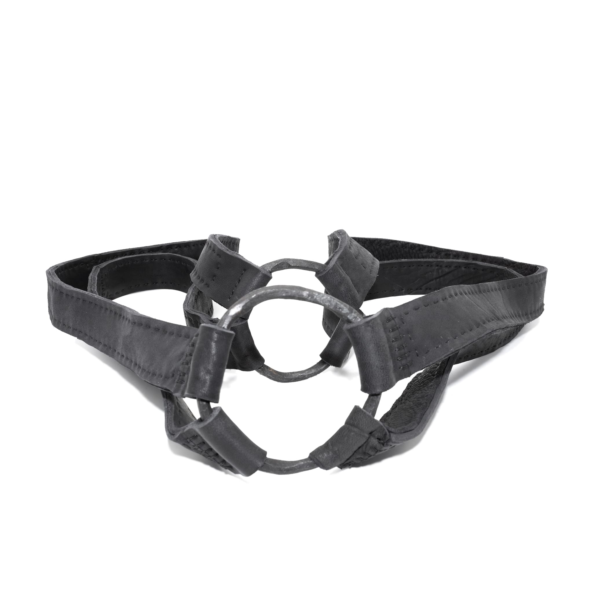 avant garde hand stitched horse culatta leather body harness, with an iron dye finish. the harness features a minimal silhouette with tonal japanese linen stitching and hand forged iron ring hardware. the leather harness is available to buy online from artisanal designer atelierskn.com 