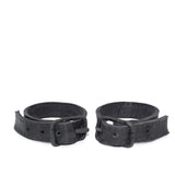 avant garde hand stitched horse culatta leather bicep belts, with an iron dye finish. the arm cuffs feature a minimal silhouette with tonal japanese linen stitching and hand forged iron buckle hardware. the arm belts are available to buy online from artisanal designer atelierskn.com 
