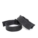 avant garde hand stitched horse culatta leather bicep belts, with an iron dye finish. the arm cuffs feature a minimal silhouette with tonal japanese linen stitching and hand forged iron buckle hardware. the arm belts are available to buy online from artisanal designer atelierskn.com 
