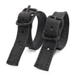 avant garde hand stitched horse culatta leather bicep belts, with an iron dye finish. the arm cuffs feature a minimal silhouette with tonal japanese linen stitching and hand forged iron buckle hardware. the arm belts are available to buy online from artisanal designer atelierskn.com 