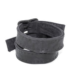 avant garde hand stitched horse culatta leather bicep belts, with an iron dye finish. the arm cuffs feature a minimal silhouette with tonal japanese linen stitching and hand forged iron buckle hardware. the arm belts are available to buy online from artisanal designer atelierskn.com 