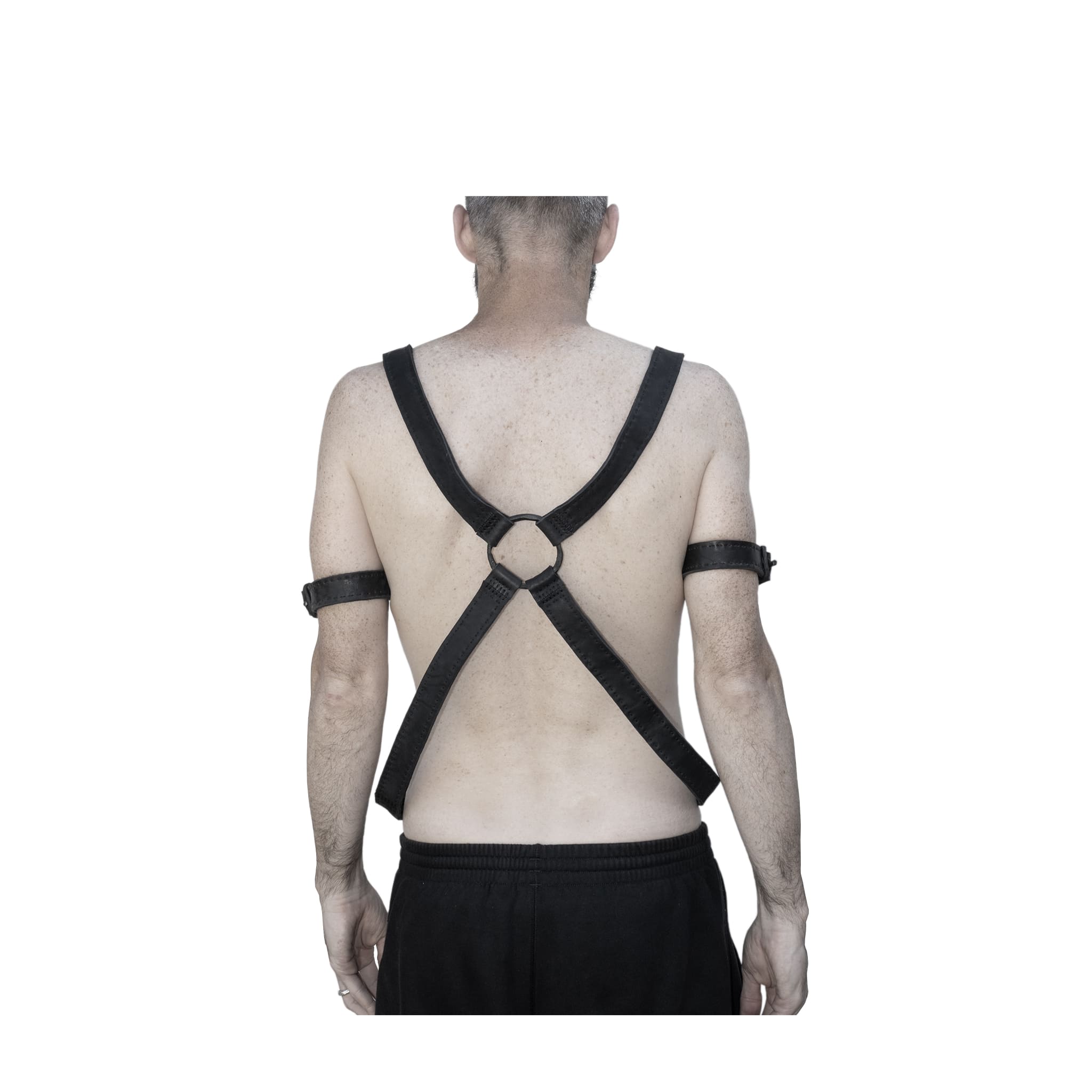 avant garde hand stitched horse culatta leather body harness, with an iron dye finish. the harness features a minimal silhouette with tonal japanese linen stitching and hand forged iron ring hardware. the leather harness is available to buy online from artisanal designer atelierskn.com 