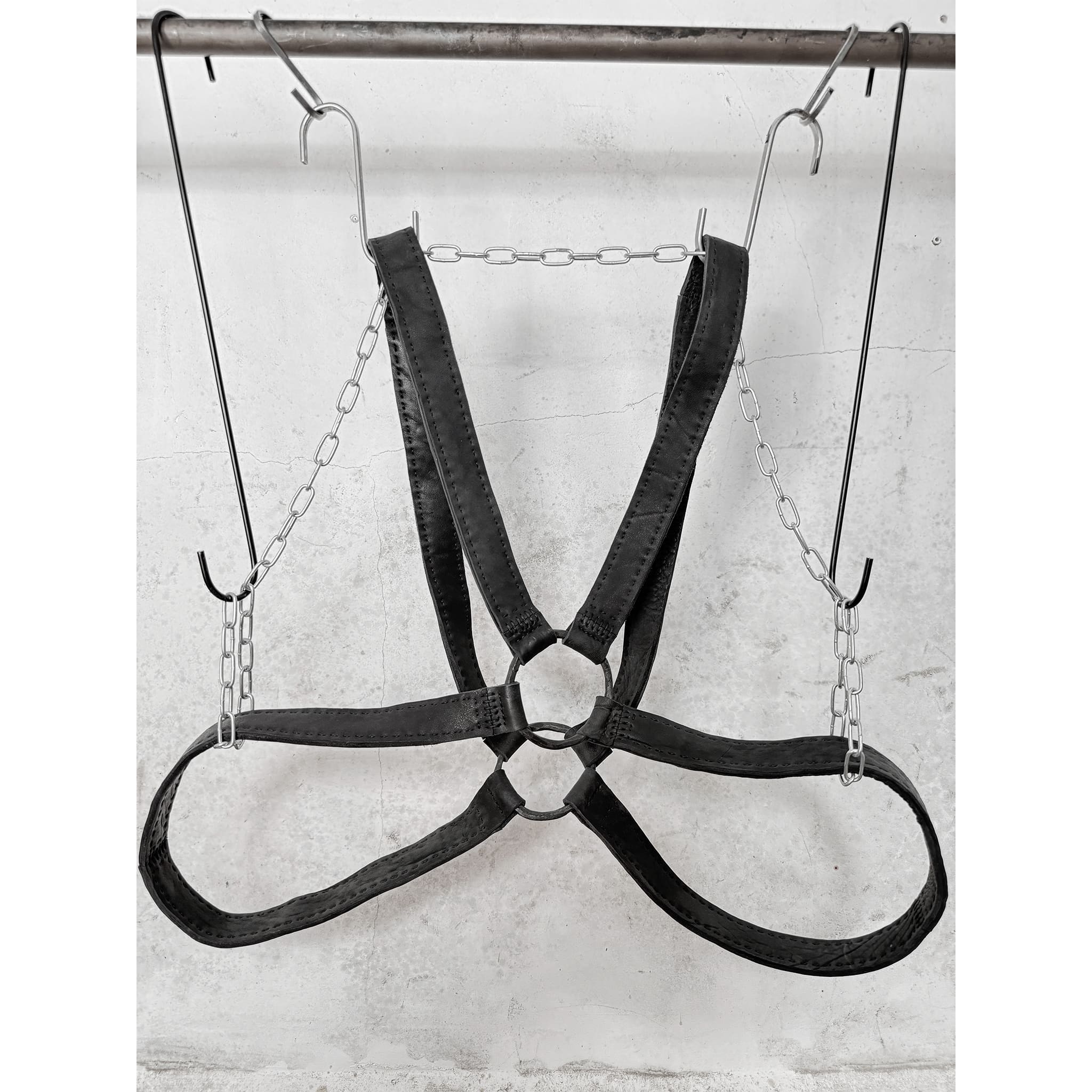 avant garde hand stitched horse culatta leather body harness, with an iron dye finish. the harness features a minimal silhouette with tonal japanese linen stitching and hand forged iron ring hardware. the leather harness is available to buy online from artisanal designer atelierskn.com 