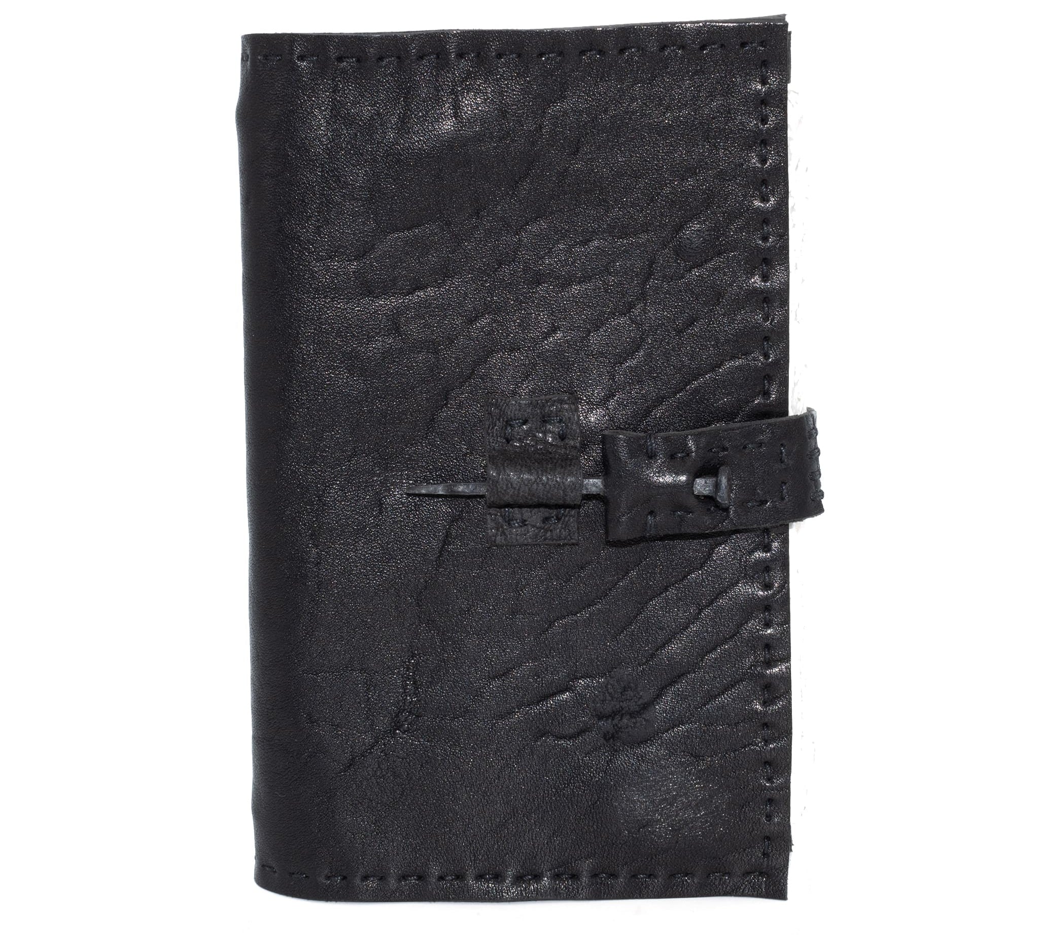 Hand stitched matte black horse culatta leather journal with a hand forged coffin nail closure and 80 pages of 150gsm handmade cotton rag paper available to buy online from artisanal uk based leather studio atelier skn.