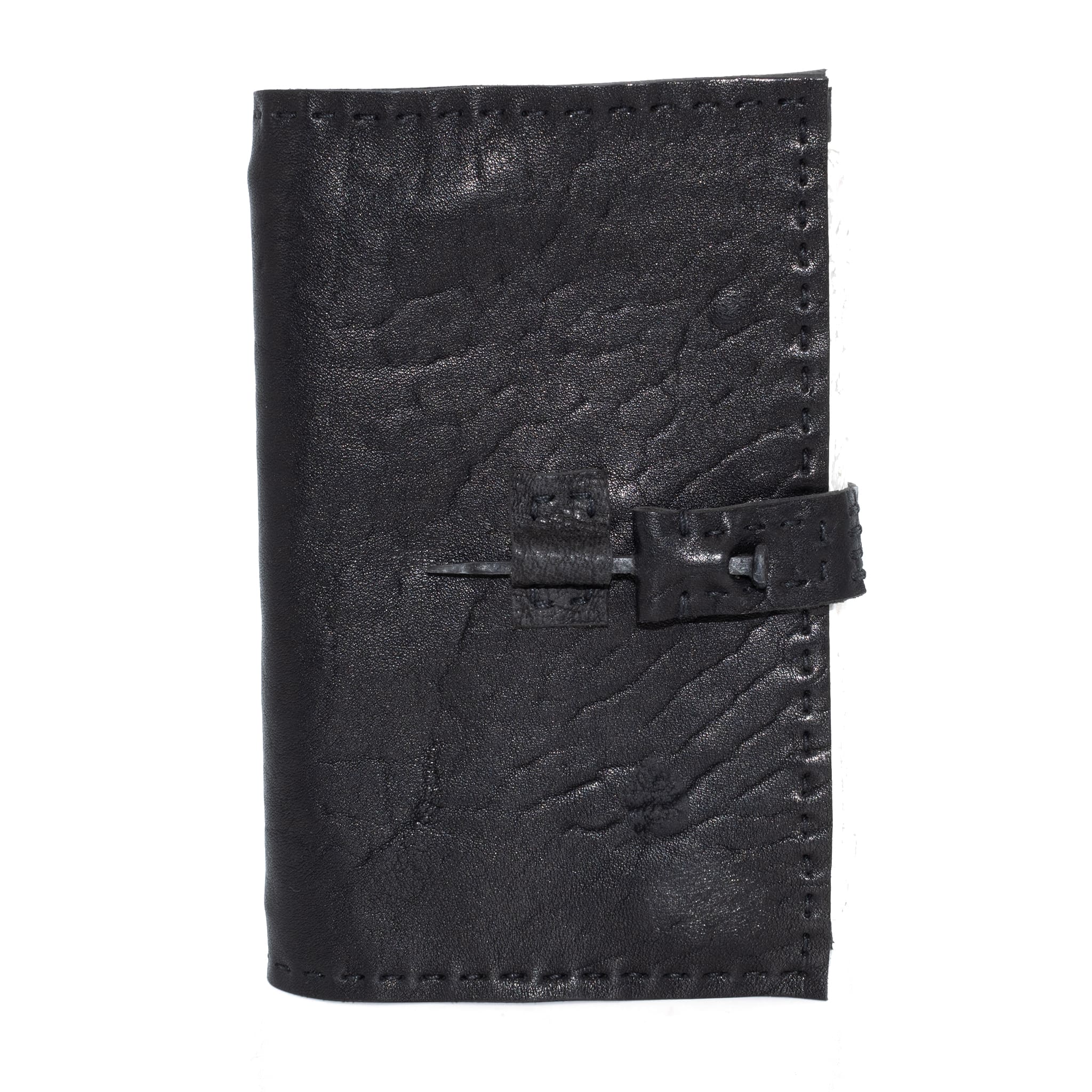 Hand stitched matte black horse culatta leather journal with a hand forged coffin nail closure and 80 pages of 150gsm handmade cotton rag paper available to buy online from artisanal uk based leather studio atelier skn.