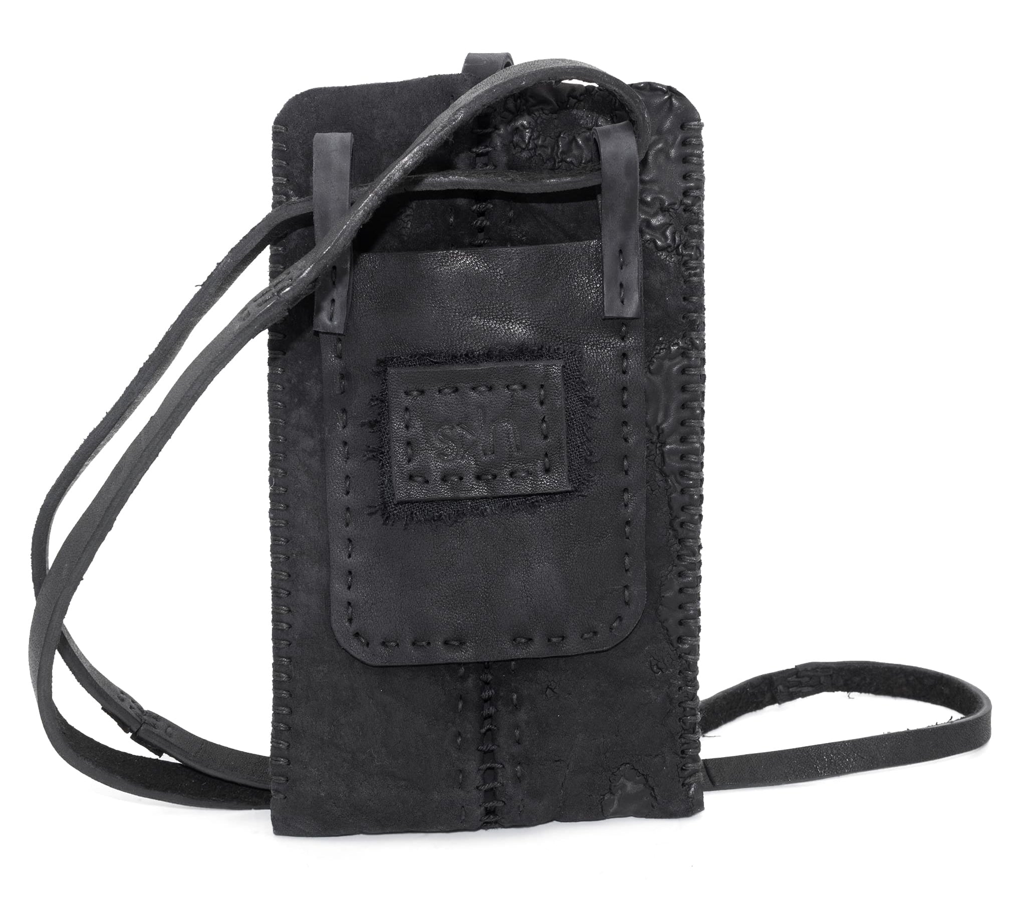 meticulously hand stitched, the washed reverse horse culatta leather phone case features a minimal silhouette with an open seam construction through the center and scar stitched sides. the bag features a distressed iron dye treatment, tonal linen stitching and a single card slot to the rear. the phone holder is available to buy online from avant garde designer atelierskn.com 
