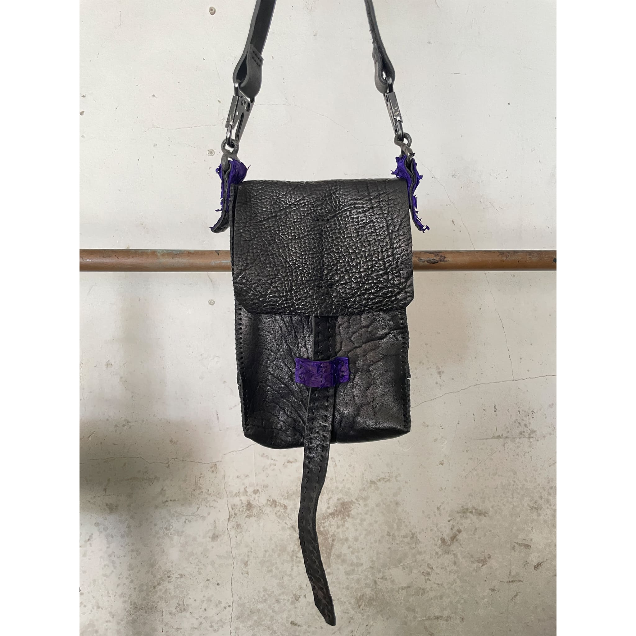 black washed culatta  and object dyed fish leather crossbody bag, with hand forged iron hardware available to buy online from avant garde leather studio atelierskn.com. an independent designer offering a fastidious collection of artisanal leather bags and accessories.