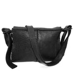 medium sized hand stitched washed horse culatta leather shoulder bag with an object dyed matte black finish. the bag features an open seam construction with a flap closure, riri zipper fastening and hand forged iron and silver hardware. the black leather bag is finished with an adjustable leather strap and is available to buy online from avant garde leather studio atelierskn.com.
