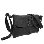 medium sized hand stitched washed horse culatta leather shoulder bag with an object dyed matte black finish. the bag features an open seam construction with a flap closure, riri zipper fastening and hand forged iron and silver hardware. the black leather bag is finished with an adjustable leather strap and is available to buy online from avant garde leather studio atelierskn.com.