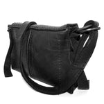 medium sized hand stitched washed horse culatta leather shoulder bag with an object dyed matte black finish. the bag features an open seam construction with a flap closure, riri zipper fastening and hand forged iron and silver hardware. the black leather bag is finished with an adjustable leather strap and is available to buy online from avant garde leather studio atelierskn.com.