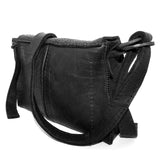 medium sized hand stitched washed horse culatta leather shoulder bag with an object dyed matte black finish. the bag features an open seam construction with a flap closure, riri zipper fastening and hand forged iron and silver hardware. the black leather bag is finished with an adjustable leather strap and is available to buy online from avant garde leather studio atelierskn.com.