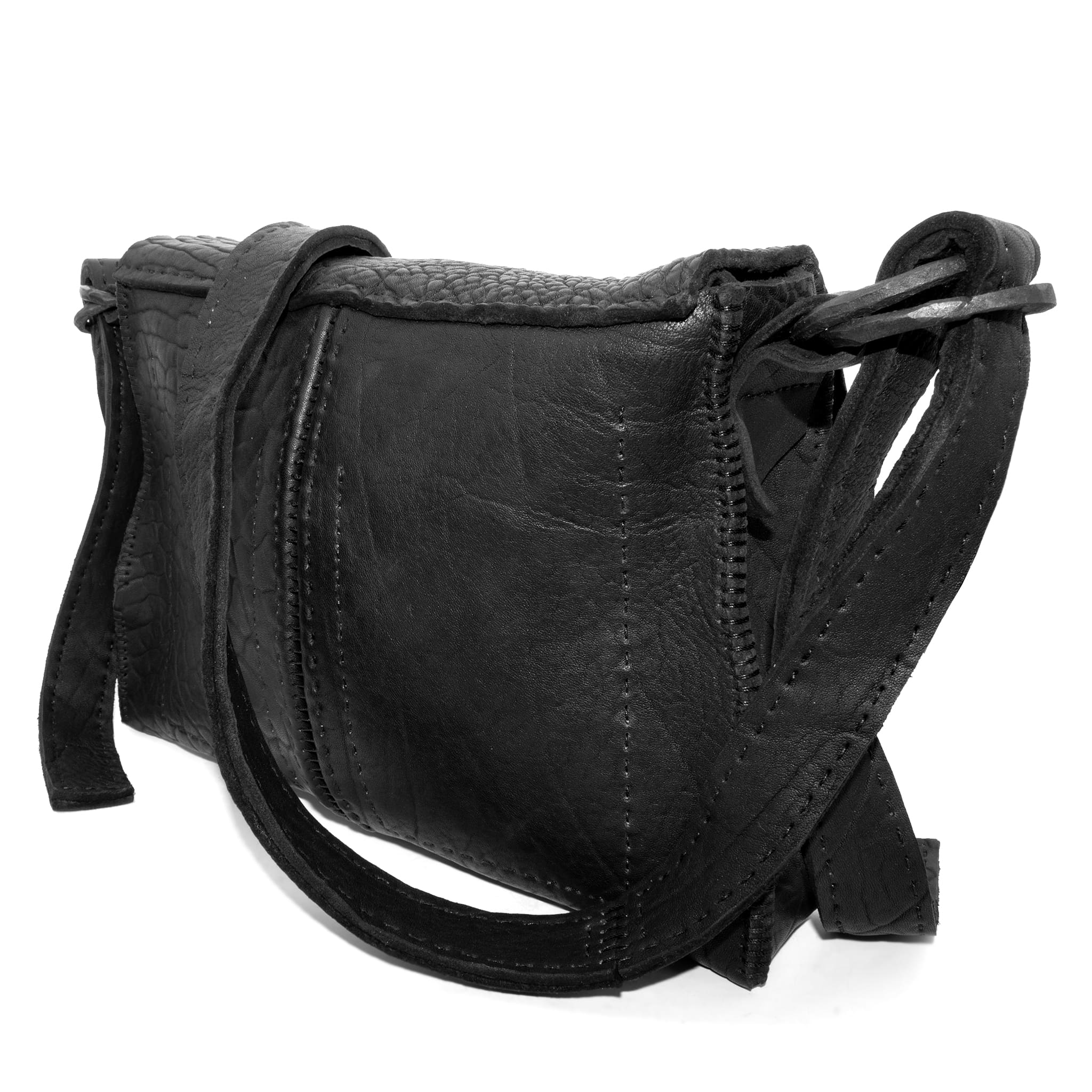 medium sized hand stitched washed horse culatta leather shoulder bag with an object dyed matte black finish. the bag features an open seam construction with a flap closure, riri zipper fastening and hand forged iron and silver hardware. the black leather bag is finished with an adjustable leather strap and is available to buy online from avant garde leather studio atelierskn.com.