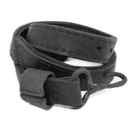 avant garde hand stitched horse culatta leather hook belt, with an iron dye finish. the belt features a minimal deconstructed silhouette with tonal japanese linen stitching and hand forged iron hook fastening. available to buy online from artisanal designer atelierskn.com 