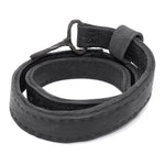 avant garde hand stitched horse culatta leather hook belt, with an iron dye finish. the belt features a minimal deconstructed silhouette with tonal japanese linen stitching and hand forged iron hook fastening. available to buy online from artisanal designer atelierskn.com 