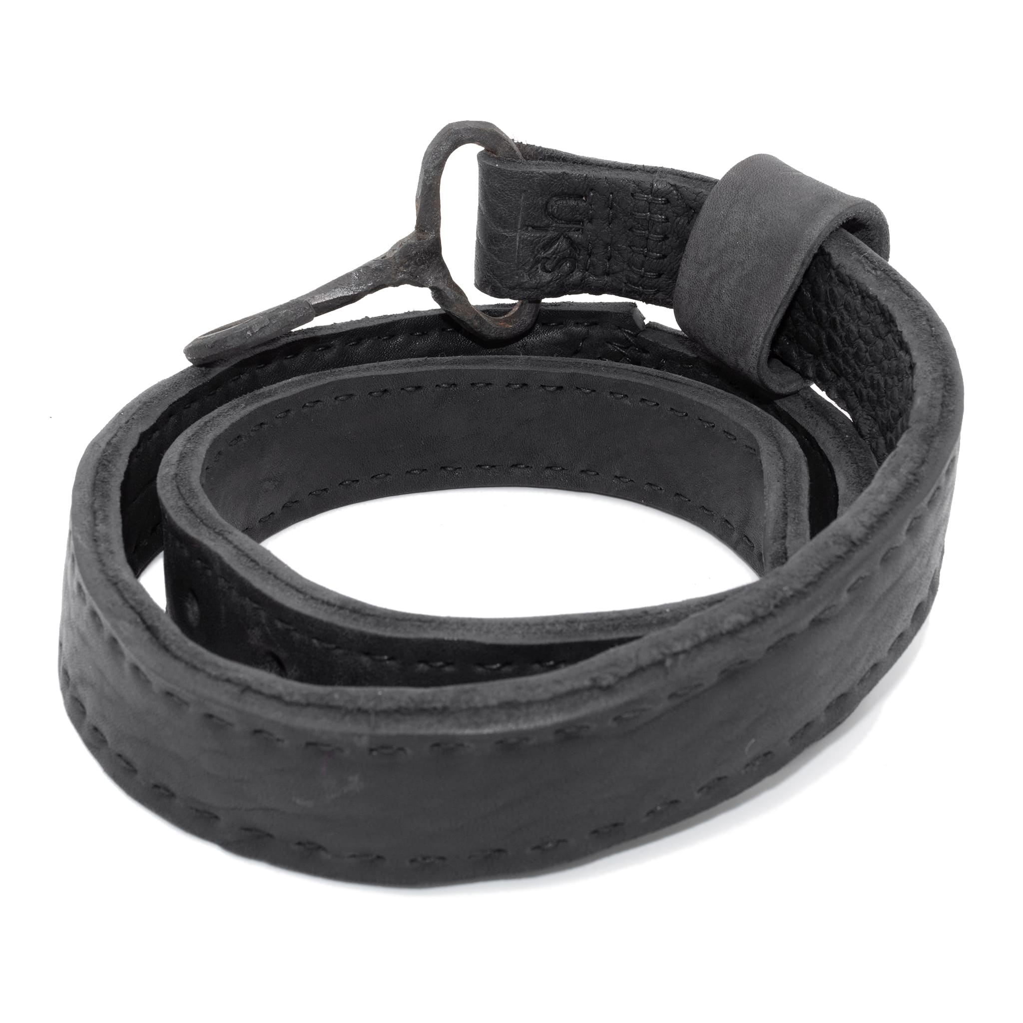 avant garde hand stitched horse culatta leather hook belt, with an iron dye finish. the belt features a minimal deconstructed silhouette with tonal japanese linen stitching and hand forged iron hook fastening. available to buy online from artisanal designer atelierskn.com 