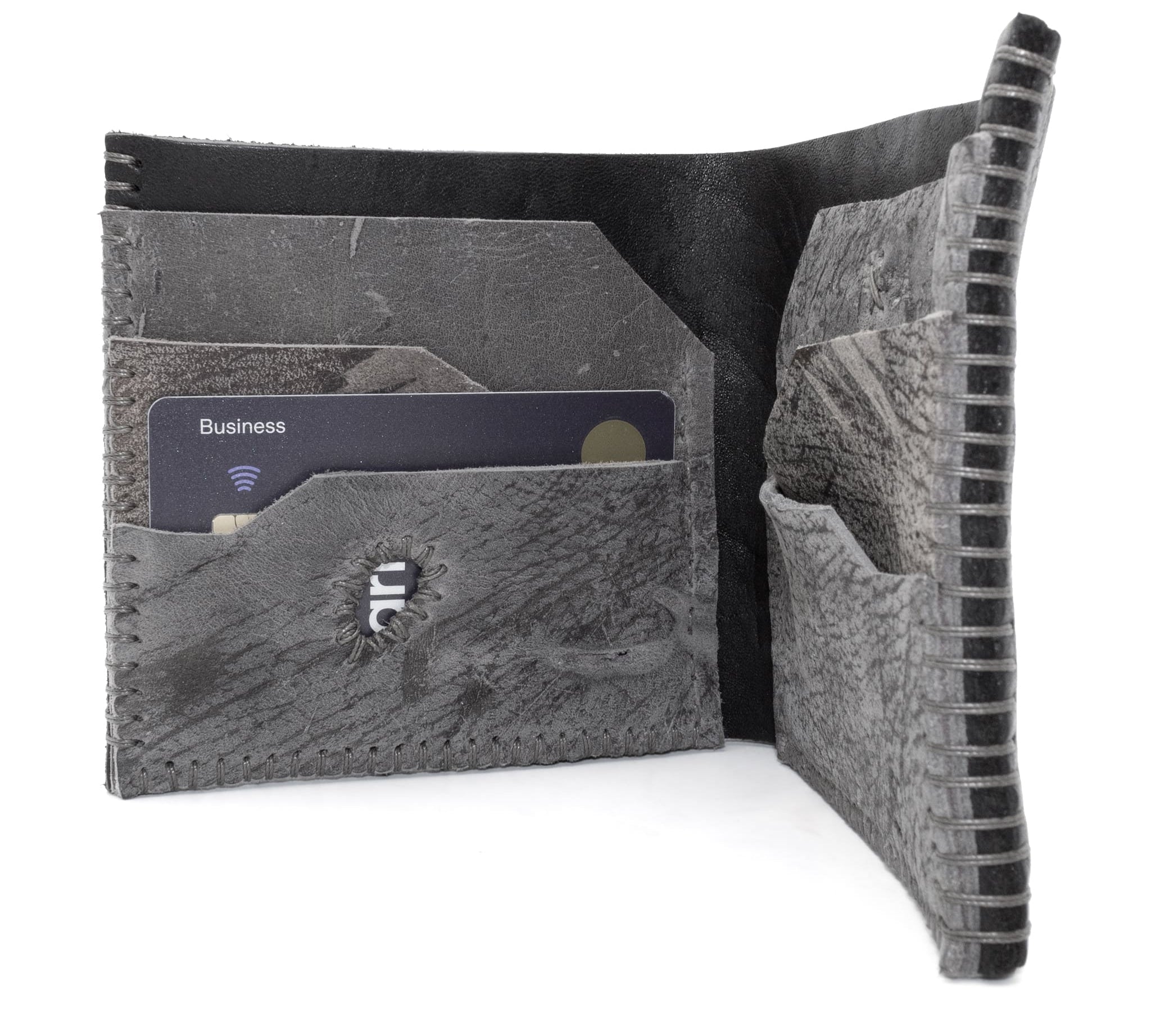 the classic wedge 6 pocket bifold wallet crafted from a supple matte black horse culatta leather with contrasting kudu leather card pockets available to buy online from artisanal leather studio atelierskn.com