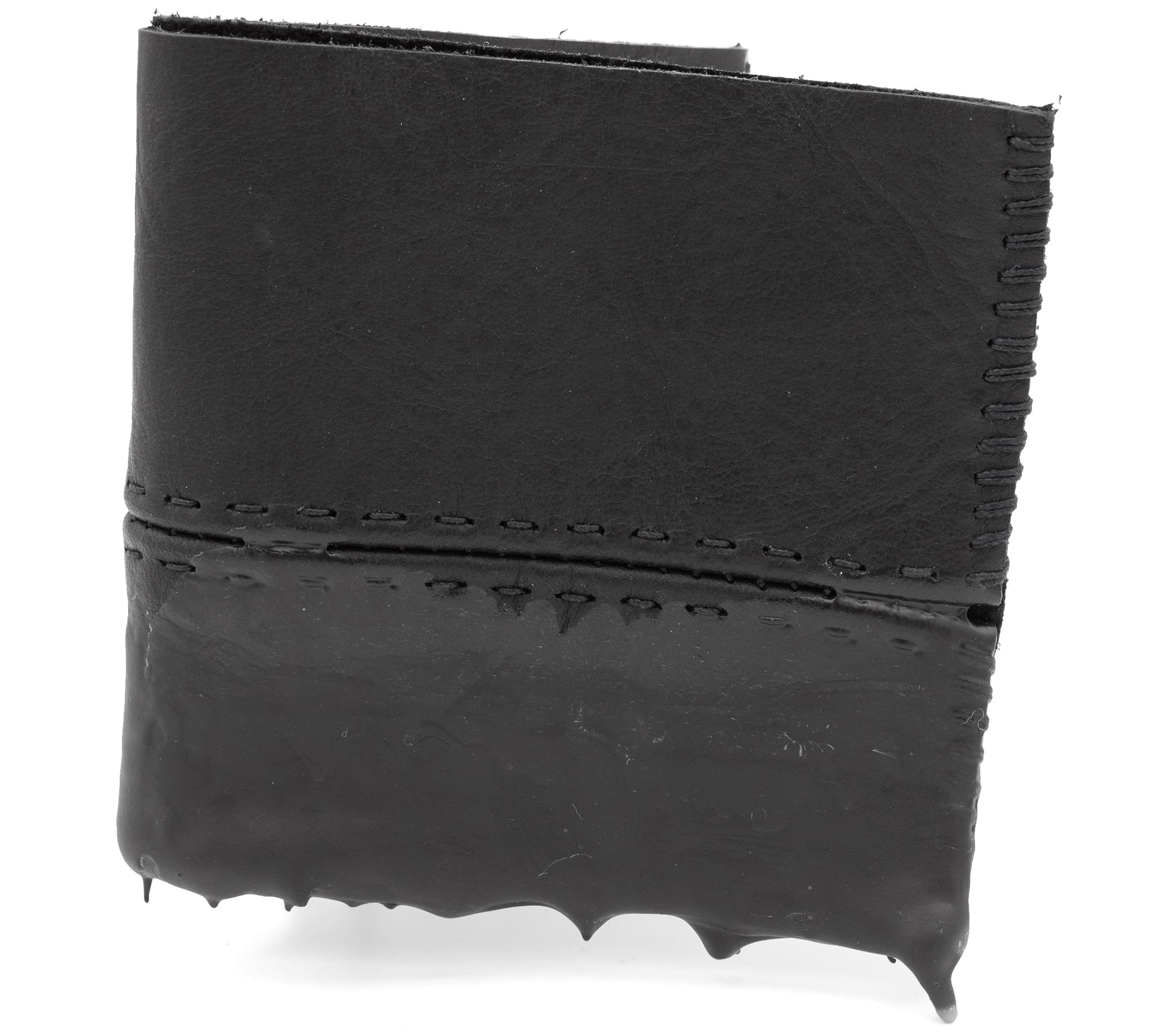 a closed seam 4 pocket bifold wallet crafted from a supple matte black washed horse leather with a closed seam construction. the wallet features a tonal rubber drip and is available to buy online from artisanal leather studio atelierskn.com