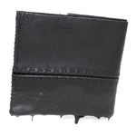a closed seam 4 pocket bifold wallet crafted from a supple matte black washed horse leather with a closed seam construction. the wallet features a tonal rubber drip and is available to buy online from artisanal leather studio atelierskn.com