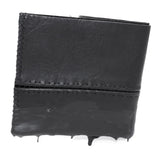 a closed seam 4 pocket bifold wallet crafted from a supple matte black washed horse leather with a closed seam construction. the wallet features a tonal rubber drip and is available to buy online from artisanal leather studio atelierskn.com