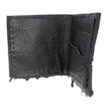a closed seam 4 pocket bifold wallet crafted from a supple matte black washed horse leather with a closed seam construction. the wallet features a tonal rubber drip and is available to buy online from artisanal leather studio atelierskn.com