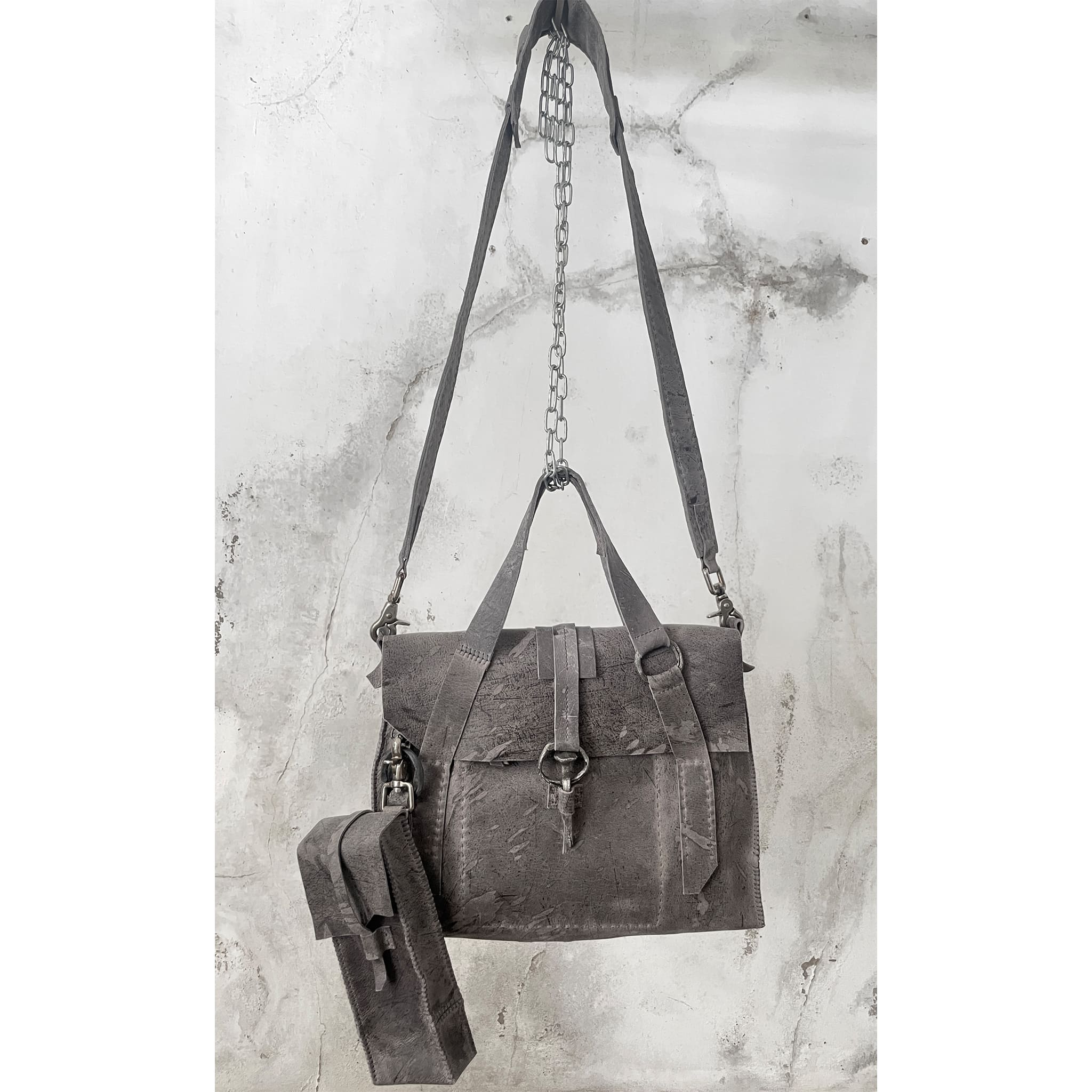 hand stitched kudu leather briefcase with hand forged wrought iron and .925 sterling silver hardware, a riri zipper closure and detachable shoulder strap is available online from avant garde leather studio atelier skn.