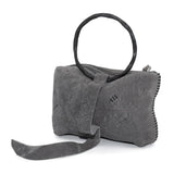 meticulously hand stitched kudu leather bag with a zipper fastening and large iron ring carry handle. an adjustable double layered shoulder strap is adorned with a distressed clip. the bag is available to buy online from uk based avant garde leather studio telierskn.com