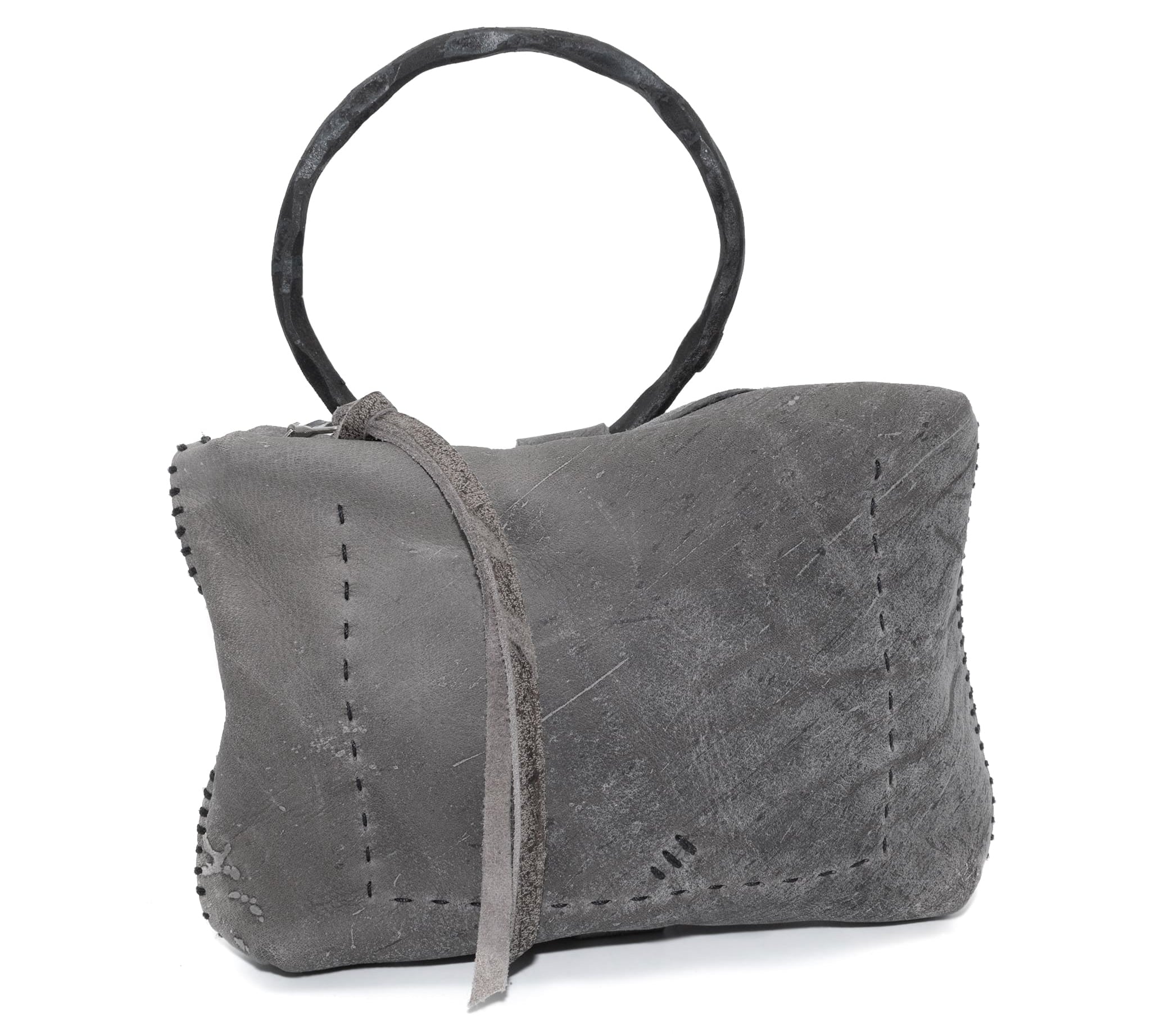 meticulously hand stitched kudu leather bag with a zipper fastening and large iron ring carry handle. an adjustable double layered shoulder strap is adorned with a distressed clip. the bag is available to buy online from uk based avant garde leather studio telierskn.com