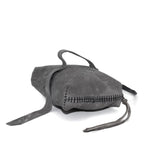 meticulously hand stitched kudu leather bag with a zipper fastening and large iron ring carry handle. an adjustable double layered shoulder strap is adorned with a distressed clip. the bag is available to buy online from uk based avant garde leather studio telierskn.com