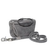 meticulously hand stitched kudu leather bag with a zipper fastening and large iron ring carry handle. an adjustable double layered shoulder strap is adorned with a distressed clip. the bag is available to buy online from uk based avant garde leather studio telierskn.com