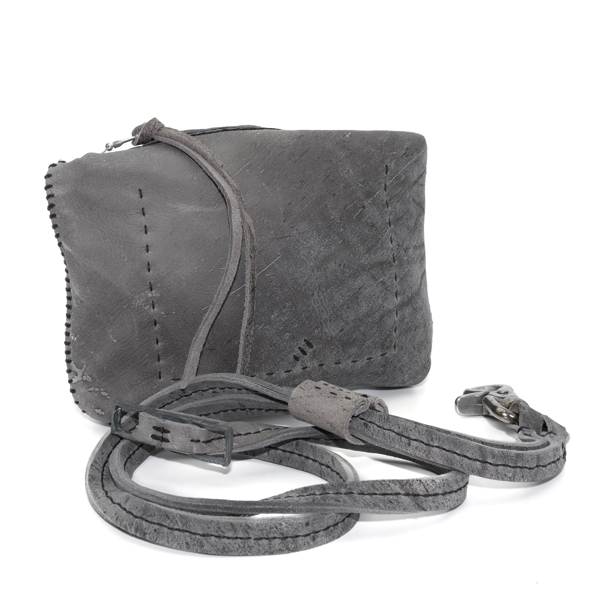 meticulously hand stitched kudu leather bag with a zipper fastening and large iron ring carry handle. an adjustable double layered shoulder strap is adorned with a distressed clip. the bag is available to buy online from uk based avant garde leather studio telierskn.com