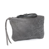 meticulously hand stitched kudu leather bag with a zipper fastening and large iron ring carry handle. an adjustable double layered shoulder strap is adorned with a distressed clip. the bag is available to buy online from uk based avant garde leather studio telierskn.com